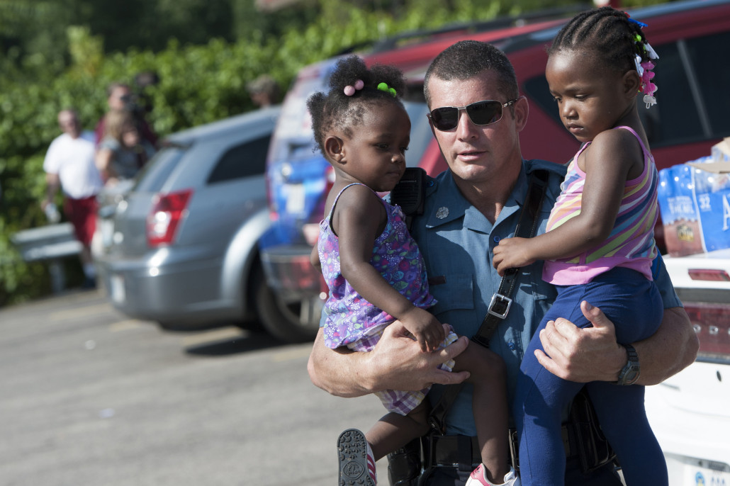 Police Officer Carrying Children